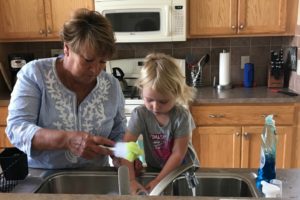 Child Doing Dishes with Grandmother