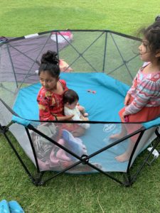 all 3 kids playing in the portable Regalo play yard