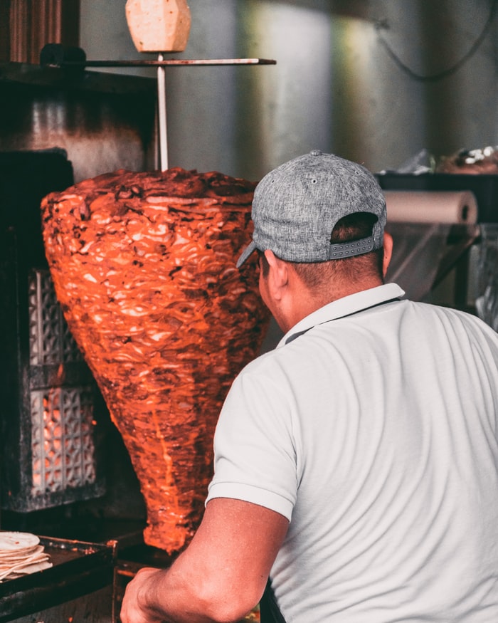 man cutting meat for national taco day