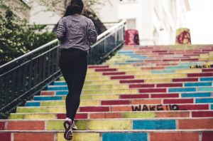 woman running up steps