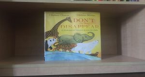 Don't Let Them Disappear displayed on a bookshelf