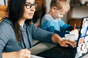 Mother Working From Home While Child Works Independently