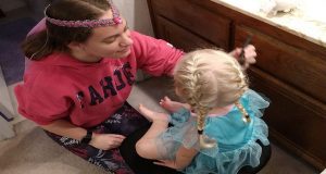 Toddler receiving a princess makeover