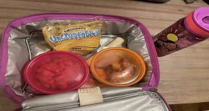 Lunch box packed with a sandwich and snacks