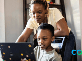 mom looking over child on laptop