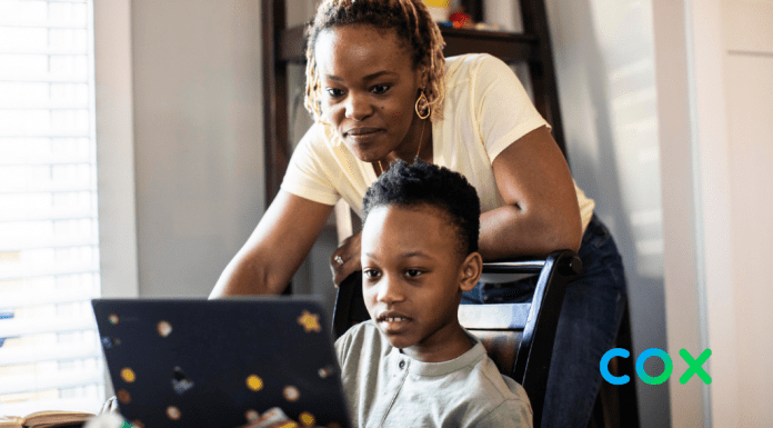 mom looking over child on laptop