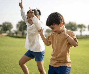 Kids dancing in the park.