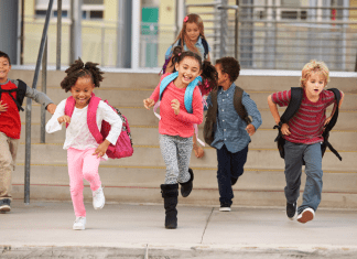 Kids running back to school with backpacks on