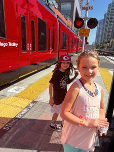 kids in front of San Diego public transit trolley