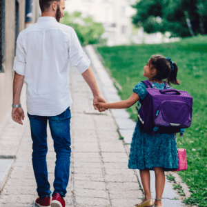 child and dad walking to school