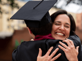 mom hugging son in cap and gown