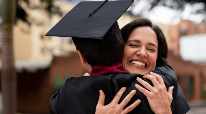 mom hugging son in cap and gown
